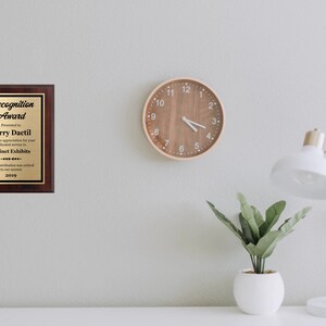 May include: A wooden plaque with a gold inscription that reads "Recognition Award" presented to Terry Dactil for dedicated service to Extinct Exhibits in 2019.