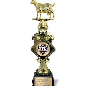 May include: A gold-colored trophy with a goat figurine on top. The trophy has a black base with a gold plaque that reads "UP TO 5 LINES OF YOUR TEXT INCLUDED CUSTOMIZE NOW!". The trophy also features the text "FFL FANTASY FOOTBALL LEAGUE".