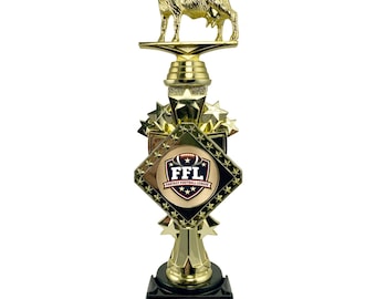 May include: A gold-colored trophy with a goat figurine on top. The trophy has a black base with a gold plaque that reads "UP TO 5 LINES OF YOUR TEXT INCLUDED CUSTOMIZE NOW!". The trophy also features the text "FFL FANTASY FOOTBALL LEAGUE".