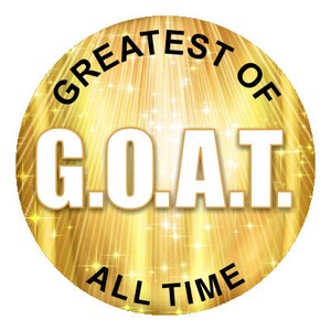 May include: A gold circle with a black border and the text "Greatest of G.O.A.T. All Time" on a background of gold rays and stars.