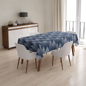 May include: A blue and white patterned tablecloth with a white tree design on a dining table with four chairs. The tablecloth is made of a soft, durable fabric and is perfect for everyday use.