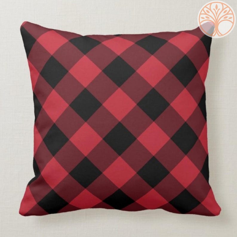 May include: Red and black plaid throw pillow with a square pattern.
