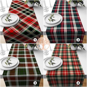 May include: Four different plaid table runners in red, green, and white. The table runners are all made of a woven fabric and have a classic plaid pattern.
