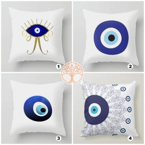 May include: Four white pillow covers with different blue evil eye designs. The first pillow has a gold evil eye with eyelashes. The second pillow has a simple blue evil eye. The third pillow has a blue evil eye with a watercolor effect. The fourth pillow has a blue evil eye with a white and blue mandala design.