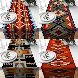 May include: Four colorful table runners with geometric patterns. The runners feature designs in red, orange, brown, black, and turquoise. Each runner is placed on a white table, with a plate and greenery on each side.