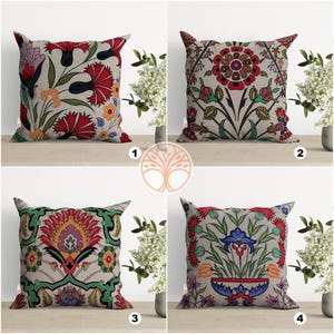 May include: Four decorative throw pillows with floral patterns. The pillows are all square and have a white background with colorful floral designs. The pillows are arranged in a grid pattern with numbers 1 through 4 in the bottom right corner of each square.