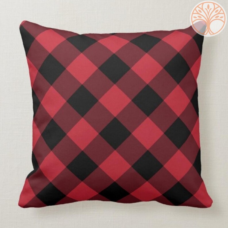 May include: Red and black plaid throw pillow with a square pattern.