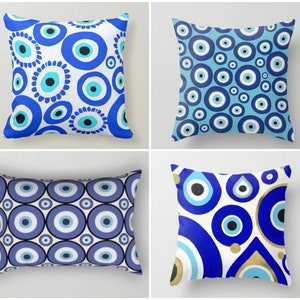 May include: Four different pillow designs featuring a blue and white evil eye pattern. The pillows are all square and have a white background with blue and white evil eyes.