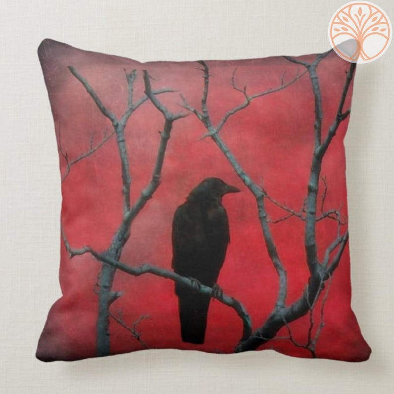 May include: A black crow silhouette perched on a bare branch against a red background. The branches are silhouetted against the red, creating a moody and atmospheric image.