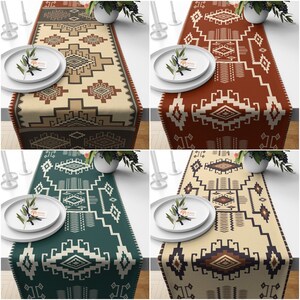 May include: Four table runners with geometric patterns in brown, green, and beige. The patterns are inspired by Native American designs. The runners are made of fabric and are perfect for adding a touch of style to any table.