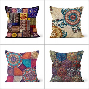 May include: Four decorative throw pillows with colorful, geometric and floral patterns. The pillows feature a variety of designs, including patchwork, mandalas, and geometric cubes. The color palette includes blues, oranges, reds, and yellows.