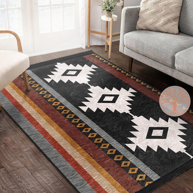 Rug Design Carpet: Black and white geometric rug with red, orange, and yellow stripes. The rug has a southwestern design with diamond shapes and a fringe border.