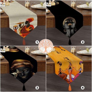May include: Four different table runners with African-inspired designs. The first runner features a beige background with a woman holding a child. The second runner is black with a woman's face in gold. The third runner is black with a woman's face in gold and a butterfly. The fourth runner is yellow with three women dancing.