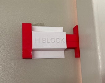 Bloqueador de puerta H - Impide que las puertas se cierren automáticamente.