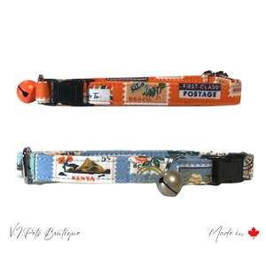 May include: Two colorful cat collars with a bell. The top collar is orange with a pattern of postage stamps and the text "First Class Postage". The bottom collar is blue with a pattern of postage stamps and the text "Kenya".