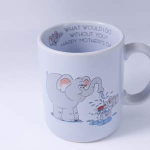 May include: A light blue ceramic mug with a handle. The mug has a cartoon illustration of two elephants. The larger elephant is pouring water on the smaller elephant. The text on the mug reads "What would I do without you? Happy Mother's Day."