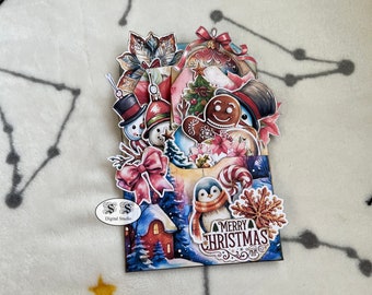 Puede incluir: Una tarjeta de Navidad pop-up con un muñeco de nieve, un hombre de jengibre, un pingüino y un árbol de Navidad. La tarjeta está decorada con papel rojo, verde y blanco y tiene las palabras "Feliz Navidad" en el frente.