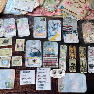 May include: A collection of vintage-style paper ephemera with a postal theme. The ephemera includes tags, stamps, and postcards with images of letters, mailboxes, and books. The text on the ephemera includes words like "letter", "postcard", "mailbox", "dearest", "reply", "pen pals", "journal", "happy mail", "hello", and "post".