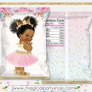 May include: A pink and white chip bag with a gold star pattern. The front of the bag features a cartoon illustration of a young Black girl wearing a pink tutu, a gold crown, and gold shoes. The text "Nutrition Facts" is printed on the back of the bag.