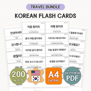 May include: Korean flash cards for travel, with 200 words and phrases. The cards have English translations and are designed for language learners. The image also includes a Korean flag and a US flag.