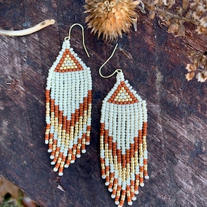 cream, gold, and dark orange/terra cotta fringe earrings