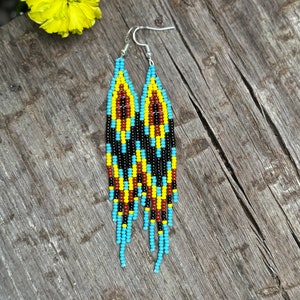 Hand woven sky blue, yellow, terracotta and black fringe earrings