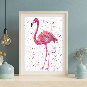 May include: A pink flamingo with a white background and colorful splatter paint. The flamingo is standing on one leg and has its head turned to the side.