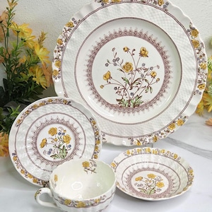 May include: A set of three ceramic mugs with a speckled, matte finish. The mugs are in shades of cream, light gray, and dark gray. Each mug has a simple, minimalist design, perfect for coffee or tea.