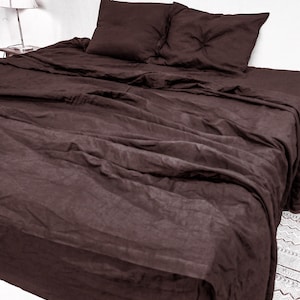 May include: A dark brown linen bedding set with a flat sheet, fitted sheet, and two pillowcases. The bedding is made of a soft, breathable linen fabric.