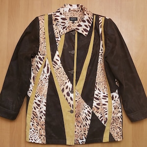 May include: A brown jacket with a leopard print and gold accents. The jacket has a button closure and a collar.