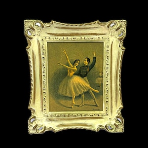 May include: A framed painting of a ballet scene. The artwork depicts a male and female dancer in a graceful pose, with a third dancer in the background. The frame is ornate, with a gold and cream color.