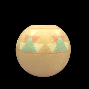 May include: A round, beige ceramic vase with a textured surface. The vase features a band of geometric designs in pastel colors, including triangles in pink, green, and white. The vase has a wide opening and a rounded body.