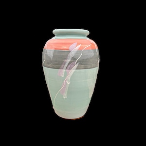 May include: A tall, ceramic vase with a wide base and a narrow neck. The vase is painted with a light teal base, a gray and orange band, and white and purple abstract designs. The vase is a decorative home decor item.