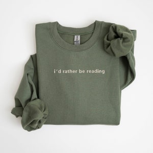 May include: A green sweatshirt with the text "i'd rather be reading" in white.