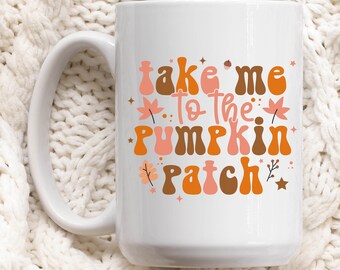 May include: White ceramic coffee mug with a colorful graphic that says "take me to the pumpkin patch".