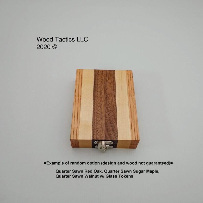 May include: A wooden box with a hinged lid and a metal latch. The box is made of three different types of wood: quarter sawn red oak, quarter sawn sugar maple, and quarter sawn walnut. The box is labelled "=Example of random option (design and wood not guaranteed)=" and "Quarter Sawn Red Oak, Quarter Sawn Sugar Maple, Quarter Sawn Walnut w/ Glass Tokens".