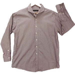 May include: A long-sleeve button-down shirt featuring a small-scale red and white gingham check pattern. The shirt includes a pointed collar, a front button placket with white buttons, and buttoned cuffs. The brand label reads Sean John.