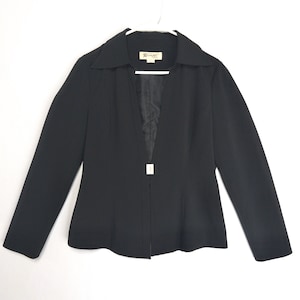 May include: A black blazer with a notched collar and long sleeves. The blazer has a single square closure at the waist and is hanging on a white hanger. The brand name "Renoir" is visible on a tag.