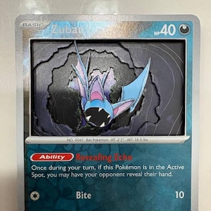 May include: A Pokémon trading card featuring Zubat, a bat-like creature. The card has a silver border and a blue and purple color scheme. The card text includes the name "Zubat", "Bite", and "Revealing Echo". The card is labeled "041/165".