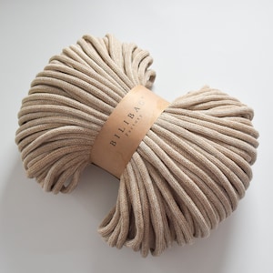 May include: A close-up of a beige and white cotton rope, wound into a coil. The rope is labelled "Bilibag Factory".