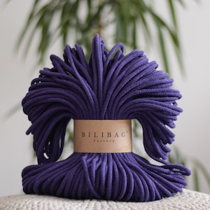 May include: A roll of deep purple cotton rope with a brown label that reads "Bilibag Factory".