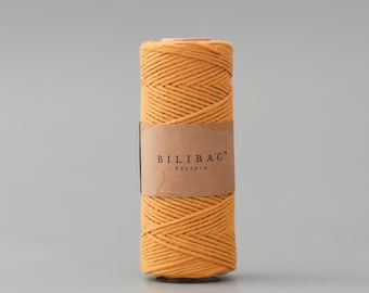May include: A spool of mustard yellow cotton rope with the text "BILIBAG™ Factory" on the label.