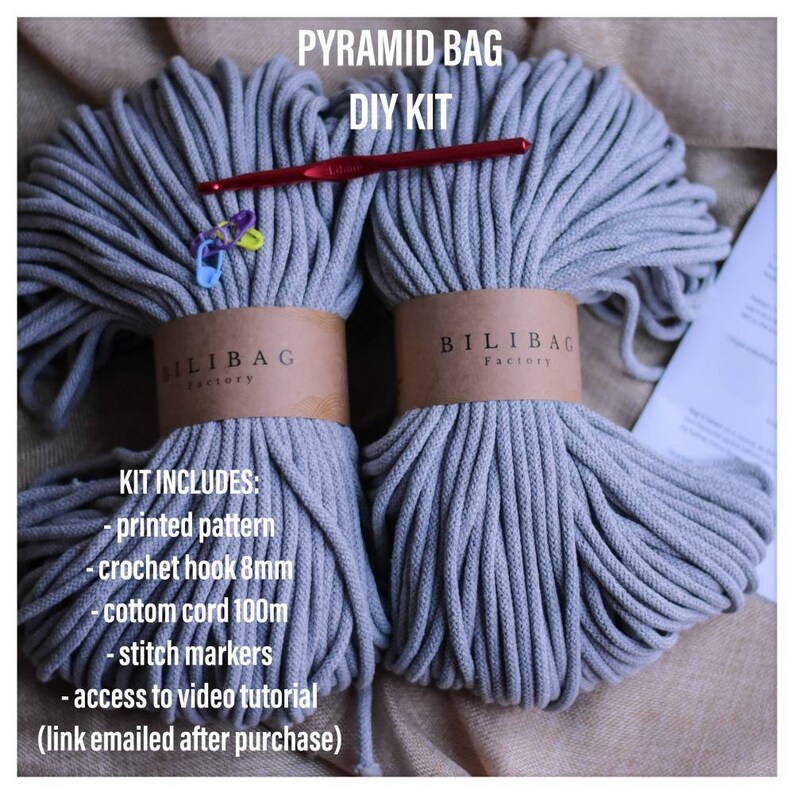 May include: A DIY kit for making a pyramid bag, including two spools of gray cotton cord, a crochet hook, stitch markers, and a printed pattern. The kit also includes access to a video tutorial.
