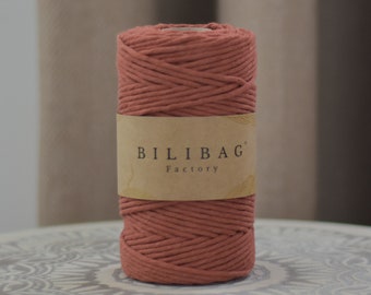 May include: A roll of terracotta-colored cotton rope with a brown label that reads "BILIBAG Factory".