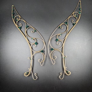 May include: A set of three ceramic mugs with a speckled, matte finish. The mugs are in shades of cream, light gray, and dark gray. Each mug has a simple, minimalist design and a rounded handle.