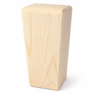 May include: A single, unfinished wooden furniture leg. The leg is a light, natural wood color with visible grain. It has a rectangular top and a slightly tapered, angled design. The leg is designed to be attached to a piece of furniture.