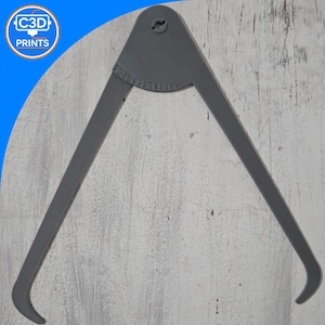 May include: A gray 3D-printed caliper tool with curved tips and a measurement scale. The tool has a pivot point at the top and is designed for measuring the diameter of objects. The logo "C3D PRINTS" is visible in the upper left corner.