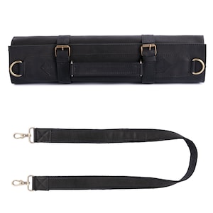 May include: Black leather knife roll with a strap and brass buckles. The roll has a handle for carrying.