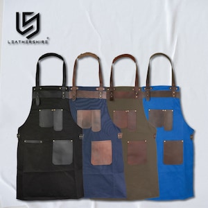 May include: Four canvas aprons with leather straps and pockets. The aprons are in black, navy blue, olive green, and royal blue.