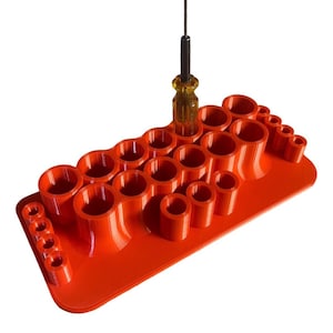 May include: Orange plastic screwdriver holder with 20 slots for holding screwdrivers. A single screwdriver is in the holder.